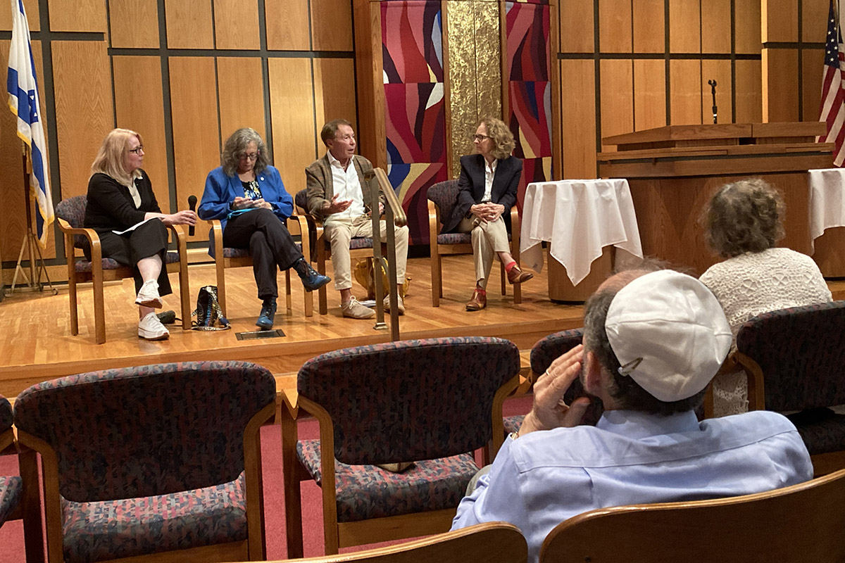 Speakers lead a social action Yom Kippur panel discussion as community members listen from the audience.